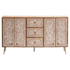 an ornately decorated sideboard with drawers