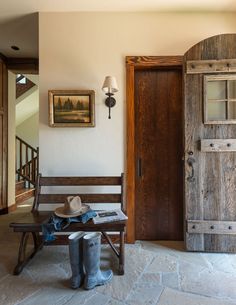 a wooden bench sitting in front of a doorway