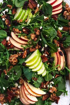 a salad with apples, spinach and walnuts