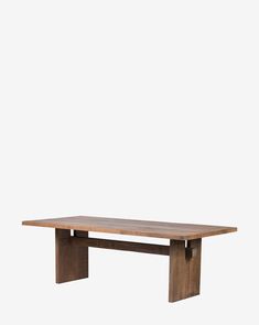 a wooden table sitting on top of a white wall