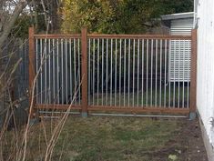 a wooden and metal fence next to a house