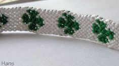 a white and green ribbon with shamrocks on it next to a pair of scissors