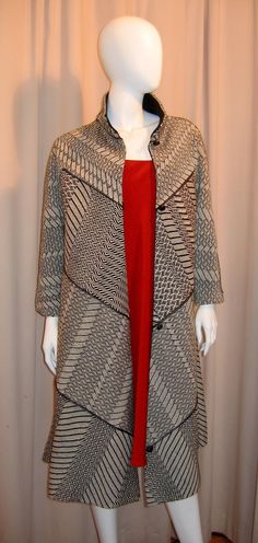 a mannequin wearing a coat and red dress