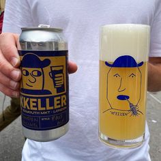 a man holding two cans of beer in his hands and another one with a face on it