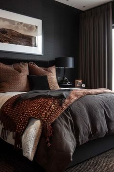 a bedroom with black walls, brown bedding and a large window in the corner