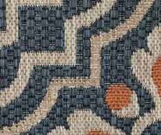 an old rug is shown with orange and blue designs on the fabric, which has been woven