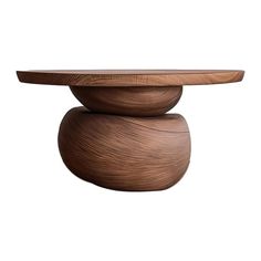 a wooden table with a circular top on it's side and a curved base