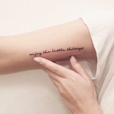 a woman's arm with a tattoo that reads, enjoy the little things