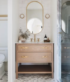 a bathroom with a sink, mirror and toilet