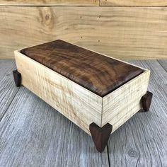 a wooden box sitting on top of a wooden table