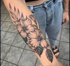 a person with a flower tattoo on their arm