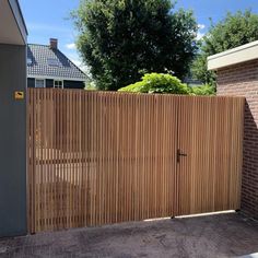 a wooden fence in front of a brick building