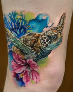 a woman's thigh with a turtle and flowers on it, both side by side