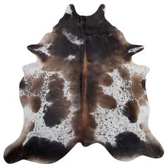 a brown and white cowhide rug on a white background