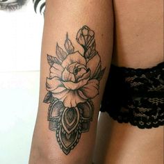 a woman's arm with a rose tattoo on it