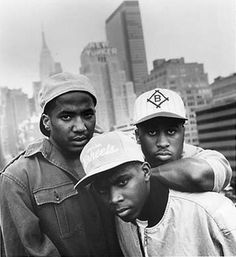 three young men in baseball caps posing for the camera