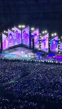 the stage is lit up with purple lights