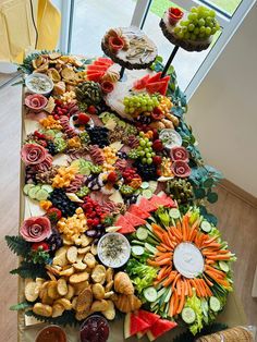 a table topped with lots of different types of food on top of a wooden floor