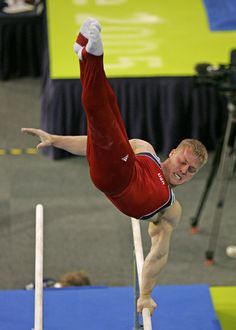 a man is performing on the parallel bars