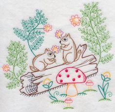 the embroidery on this towel shows two bears sitting on a log with mushrooms and flowers