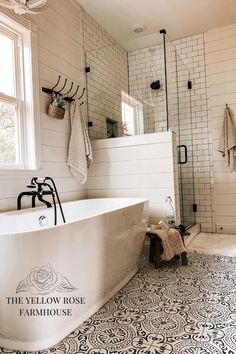 a white bath tub sitting next to a walk in shower