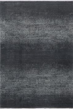 an area rug with dark gray and white colors