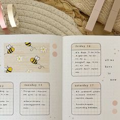 an open planner with bees on it next to a straw bag and some clothes pins