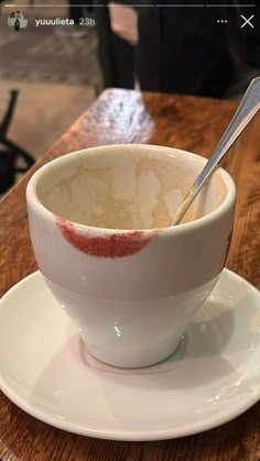 a white bowl filled with soup on top of a wooden table