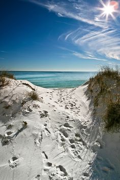 the path to the beach is covered in white sand