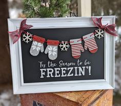 a sign that says it's the season to be frizin'with stockings and snowflakes