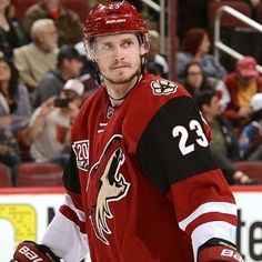 a hockey player is standing on the ice