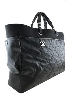 Details & Care Travel in style with this  Chanel Quilted Coated Canvas Paris Biarritz Weekender Travel Bag beautifully crafted from black diamond quilted waterproof coated canvas with a black heavy-duty knit canvas trim and silver-tone hardware. It features a single flat shoulder strap, a frontal compartment with a signature 'CC' zip closure and two large side snap pockets. This ultra-spacious, light-weight travel companion will hold all your essentials with ease! Shop  designer handbags by Chanel at Bags Alora. Condition: Excellent. Brand new condition. Very gentle wear is present but is hardly noticeable. The interior is perfect.  Black quilted coated canvas Flat top handles, 8'' drop Silver-tone hardware Front 'CC' zip compartment Two side snap pockets Fine textile lining Removable Canvas Flats, Weekend Travel Bags, Side Snap, Waterproof Coat, Travel In Style, Dior Shoes, Girl Backpacks, Flats Top, Black Canvas