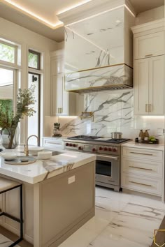 a large kitchen with marble counter tops and white cabinets, along with an island in the middle