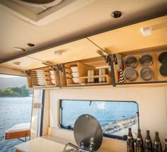 the inside of a camper with pots and pans hanging from it's ceiling