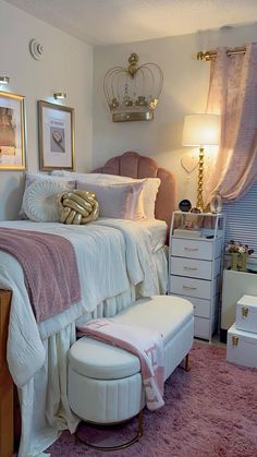 a white bed sitting in a bedroom next to a pink rug