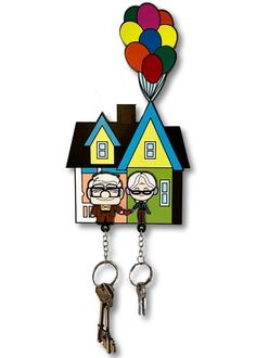 a house shaped key holder with two people and balloons attached to the front of it