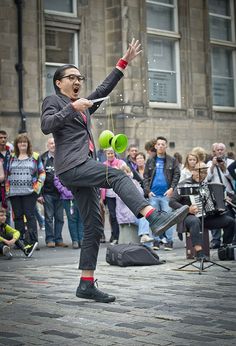 a man juggling balls in front of a crowd