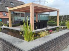 an outdoor living area with a pond and patio furniture