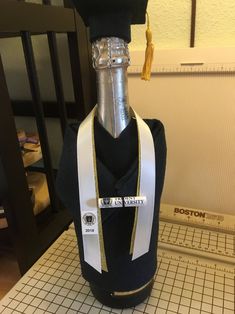 a bottle that is sitting on a table with a ribbon around it's neck