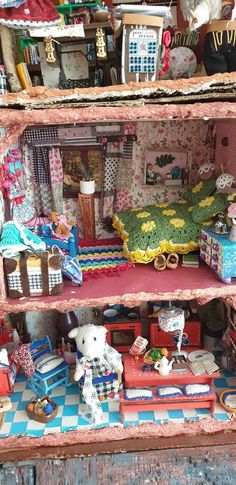 a doll house with furniture and accessories on display