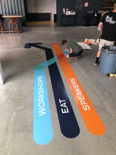 two men are working on a large sign