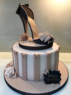 a birthday cake decorated with high heels and flowers