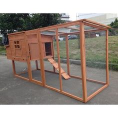 a large wooden chicken coop in the middle of a parking lot