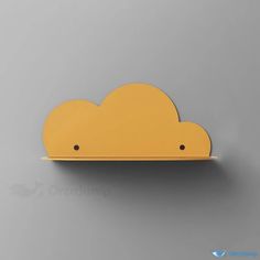 a yellow cloud shaped object on a gray surface