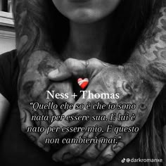 a woman with tattoos holding her hands together