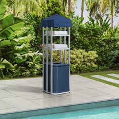 a blue and white tower next to a swimming pool