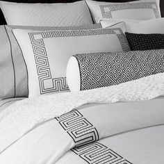 a black and white photo of a bed with pillows