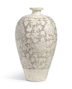 a white and brown vase with flowers on the bottom is sitting in front of a white background