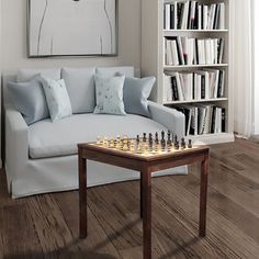 a living room with a couch, chess board and bookshelf in the corner