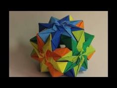 an origami ball with some sort of star on it's side and another object in the middle